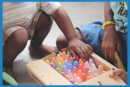 children picking out chalks from a box