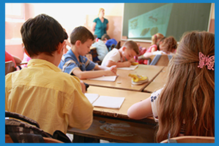 classroom full of children with teacher at the front