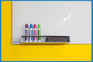 whiteboard on a yellow wall, with whiteboard pens