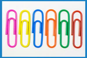 6 paperclips, in different colours, on a white background