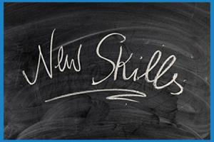 "new skills" written on a blackboard in curly letters